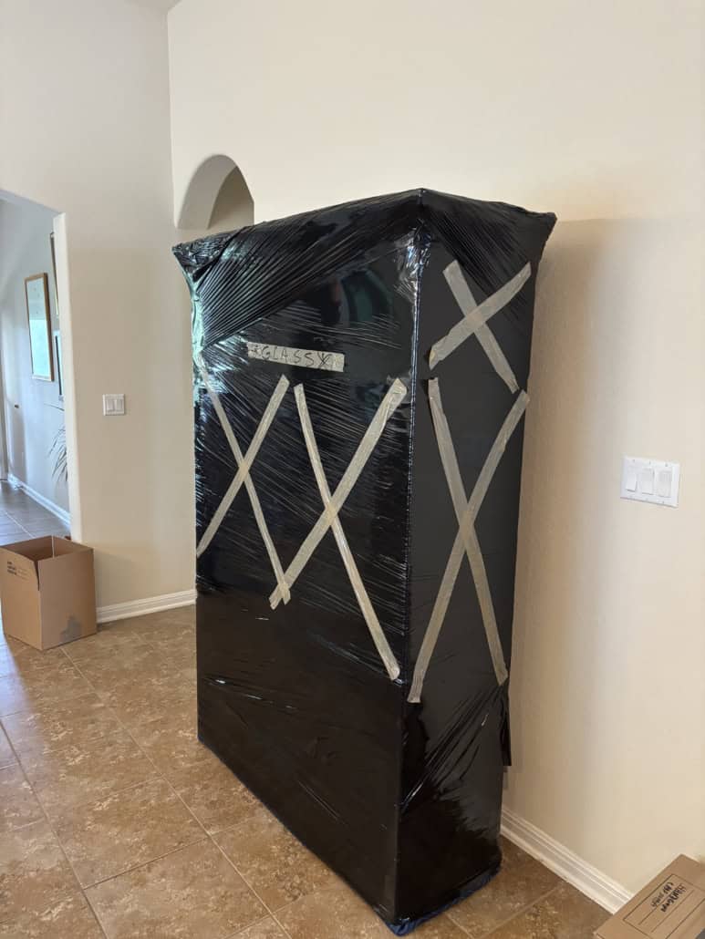 Moving wardrobe wrapped in plastic for protection.