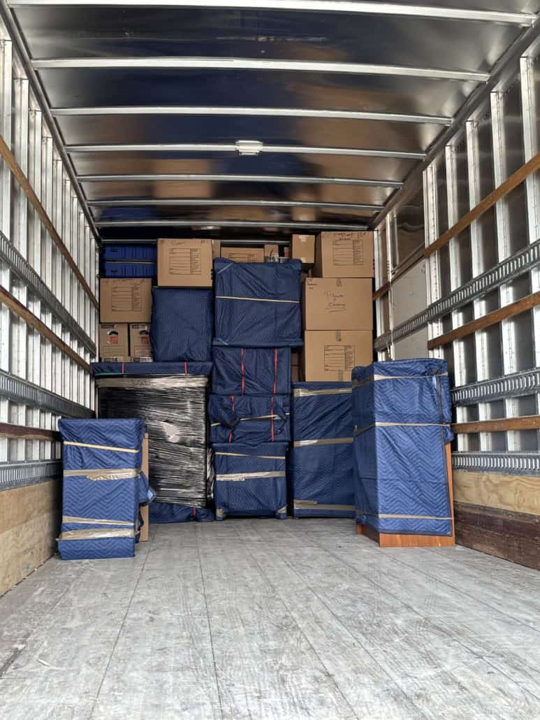 Moving truck interior filled with packed boxes and furniture for a smooth move.